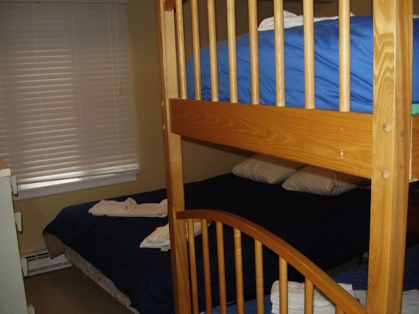 Queen-sized bed and bunk beds in second bedroom